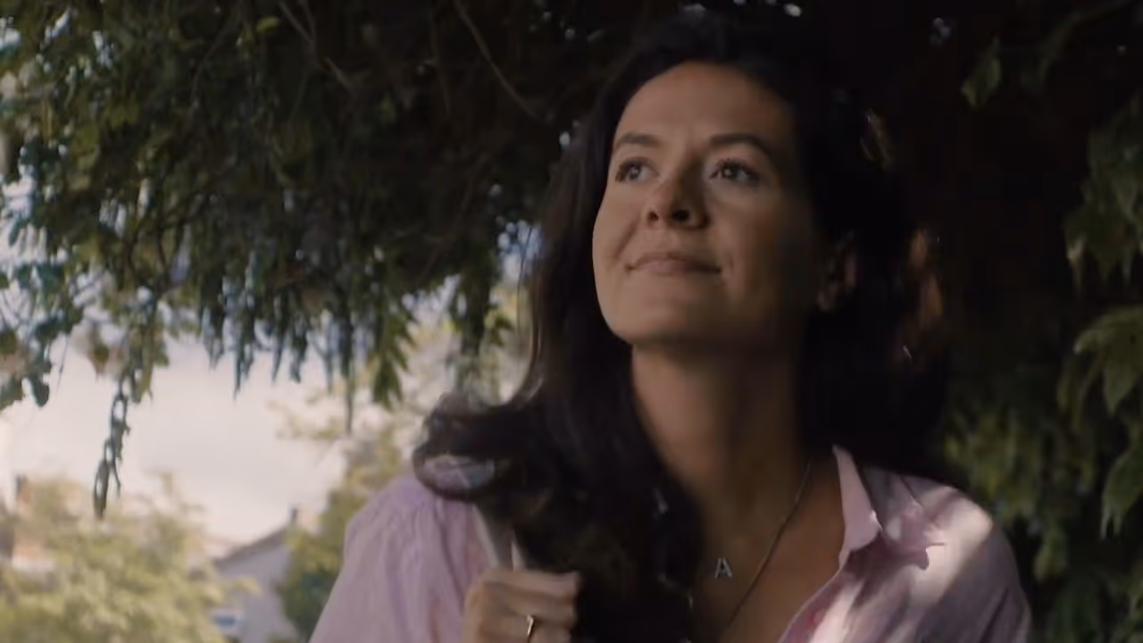Woman smiling standing under a tree